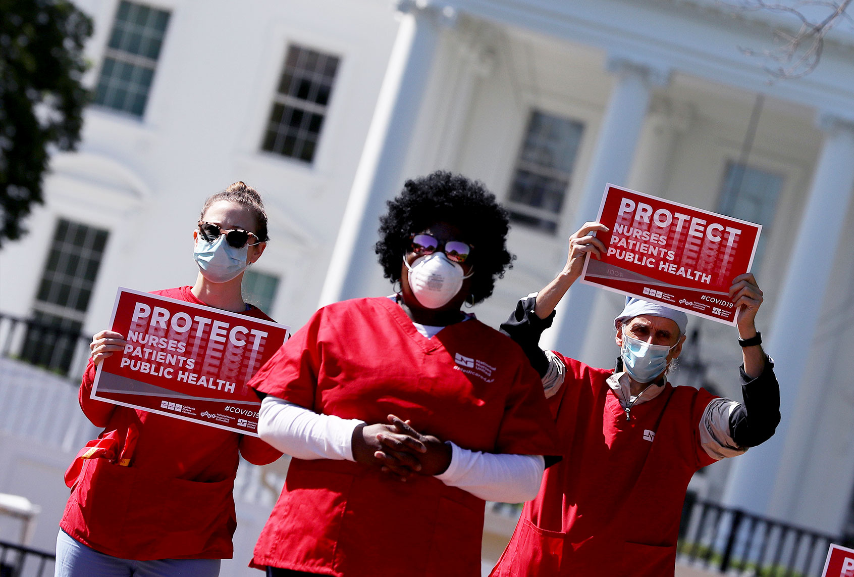 Members of the National Nurses United read the names of the 88 nurses they say have died from COVID-19 while demonstrating in Lafayette Park across from the White House May 07, 2020 in Washington, DC. The union is protesting during Nurses' Week to demand that their employers and the federal government 'provide safe workplaces by providing optimal personal protective equipment (PPE), safe staffing, presumptive eligibility for workers’ compensation benefits and more during the novel coronavirus pandemic. (Chip Somodevilla/Getty Images)