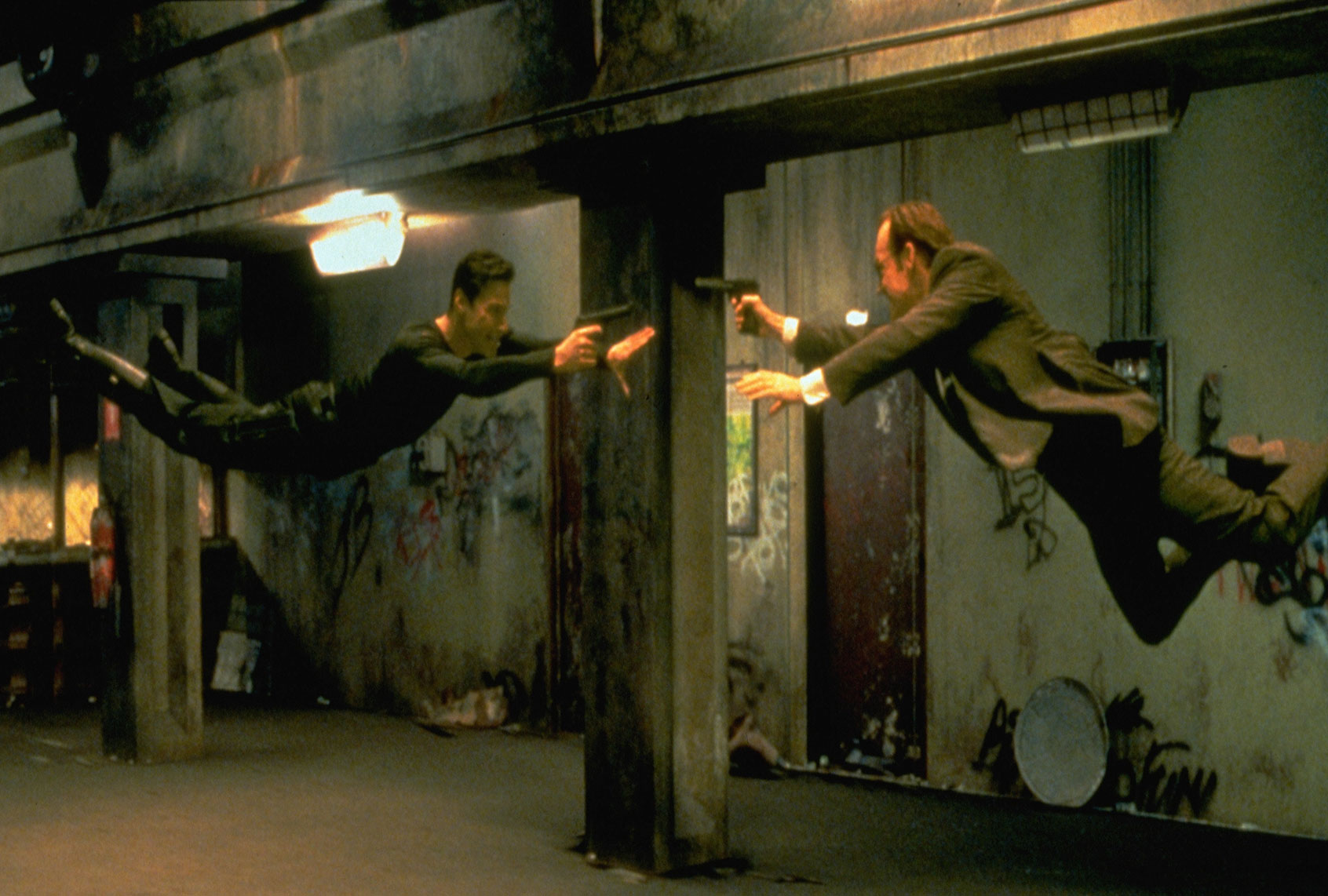 Keanu Reeves and Hugo Weaving face each other in a scene from The Wachowski's 1999 movie "The Matrix" (Ronald Siemoneit/Sygma/Sygma via Getty Images)