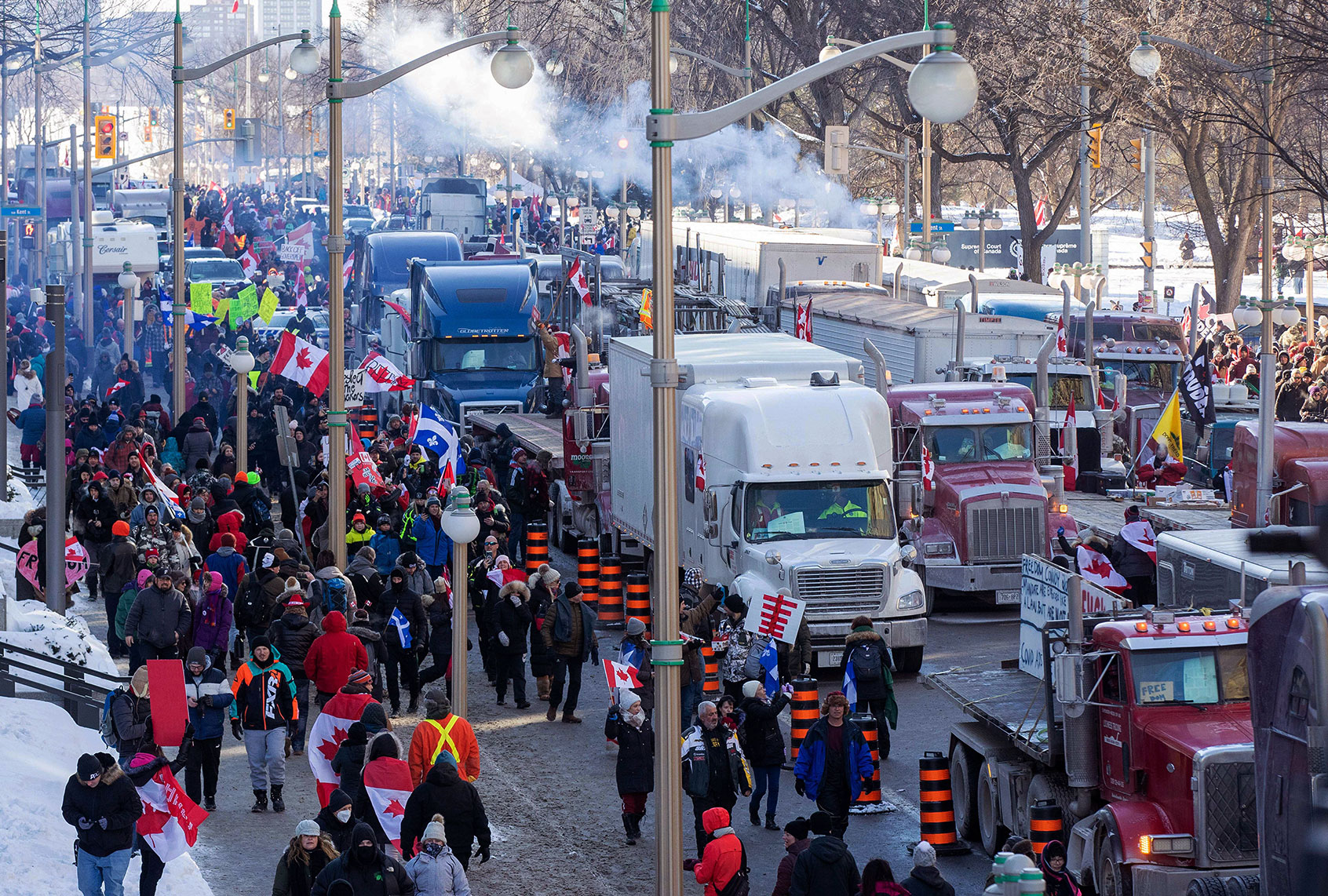 Supporters arrive at Parliament Hill for the Freedom Truck Convoy to protest against Covid-19 vaccine mandates and restrictions in Ottawa, Canada, on January 29, 2022. - Hundreds of truckers drove their giant rigs into the Canadian capital Ottawa on Saturday as part of a self-titled "Freedom Convoy" to protest vaccine mandates required to cross the US border. (LARS HAGBERG/AFP via Getty Images)
