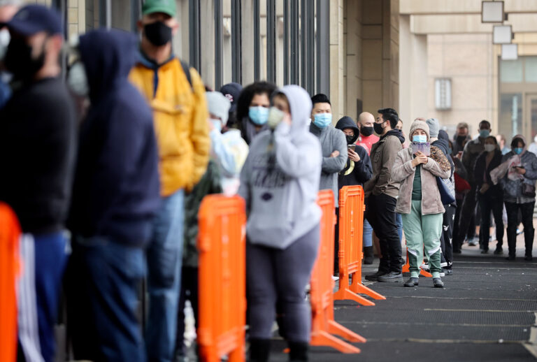 People wait in line to be tested for COVID-19 at Union Station on January 7, 2022 in Los Angeles, California. A free distribution of COVID rapid test kits for those who received vaccination shots or booster shots was also held nearby in Union Station. Thirty new deaths and over 37,000 new cases of COVID-19 were reported by Los Angeles County amid the continued spread of the Omicron variant. (Mario Tama/Getty Images)