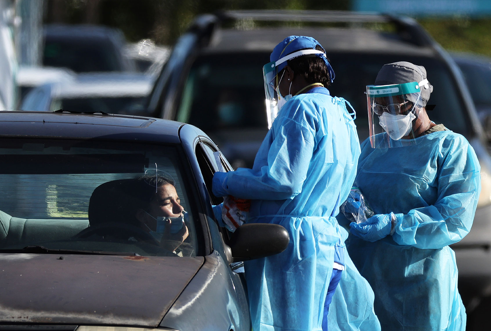 Healthcare workers conduct tests at a drive-thru COVID-19 testing site at the Dan Paul Plaza on December 29, 2021 in Miami, Florida. In response to the increasing demand for COVID-19 tests, Miami-Dade County opened two new testing sites and expanding hours at the Zoo Miami testing location. The Zoo Miami testing site is now open 24 hours a day, seven days a week. (Joe Raedle/Getty Images)