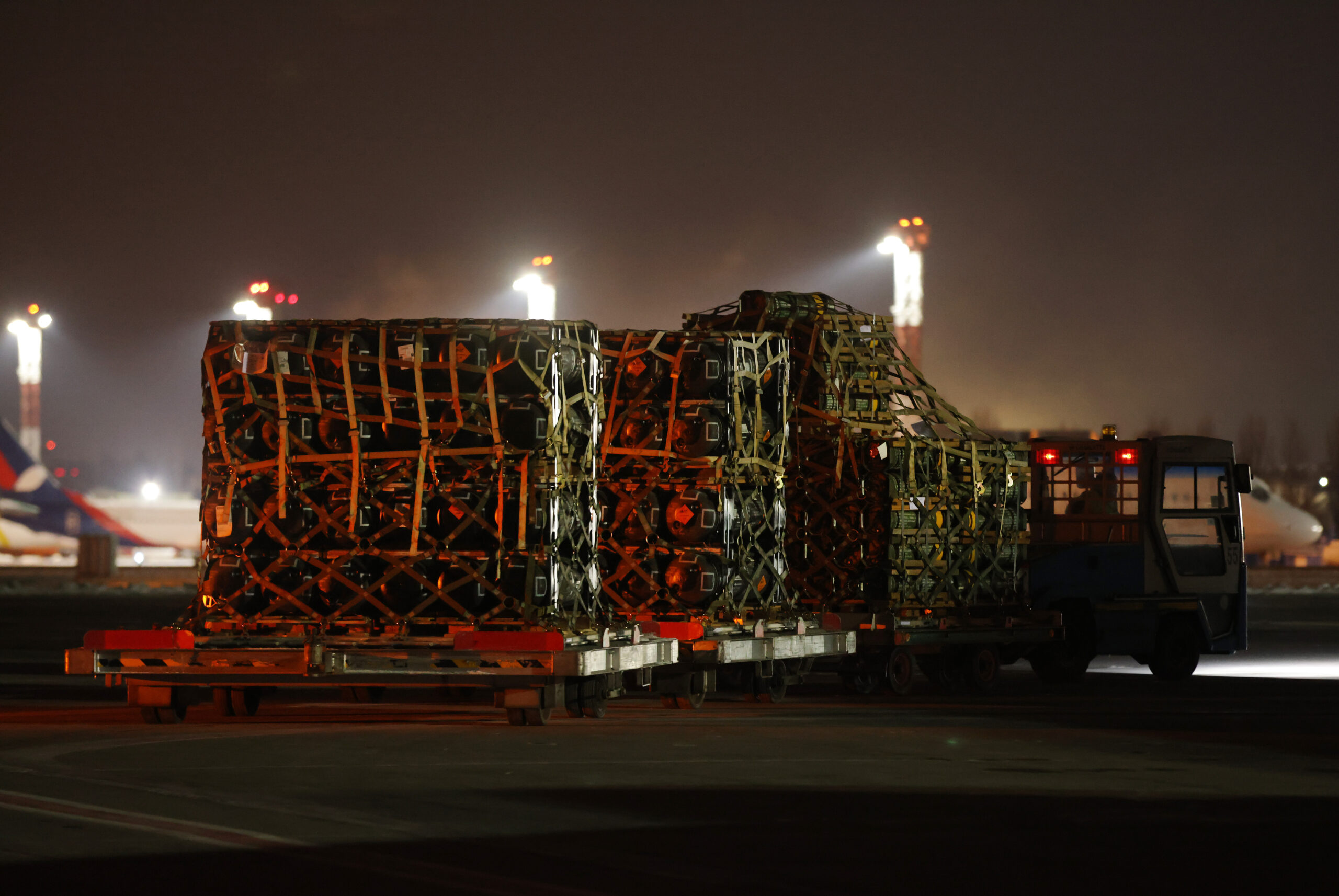 An airport vehicle pulls a shipment of weapons that include Javelin anti-tank missiles and other military hardware delivered by the U.S. military at Boryspil Airport near Kyiv, Ukraine, on Jan. 25. (Sean Gallup/Getty Images)