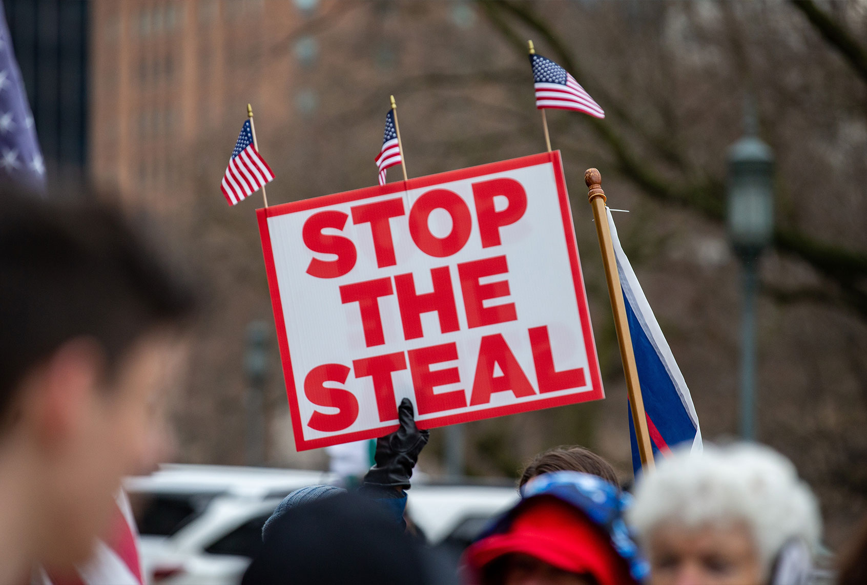A protester holds a "stop the steal" placard during a pro-Trump demonstration. (Paul Weaver/SOPA Images/LightRocket via Getty Images)