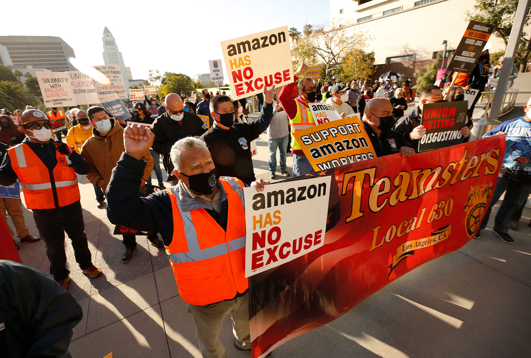 Jose Haro, Felipe Medina and Lou Villalvazo, left to right, with Teamsters Local 63 joined union workers as they rallied in downtown Los Angeles Monday morning in support of unionizing Alabama Amazon workers. Local labor union members, elected officials, clergy, and community members held the rally to call attention to the ever-growing union-busting industry and culture used to suppress workers' rights across the nation. (Al Seib / Los Angeles Times via Getty Images)