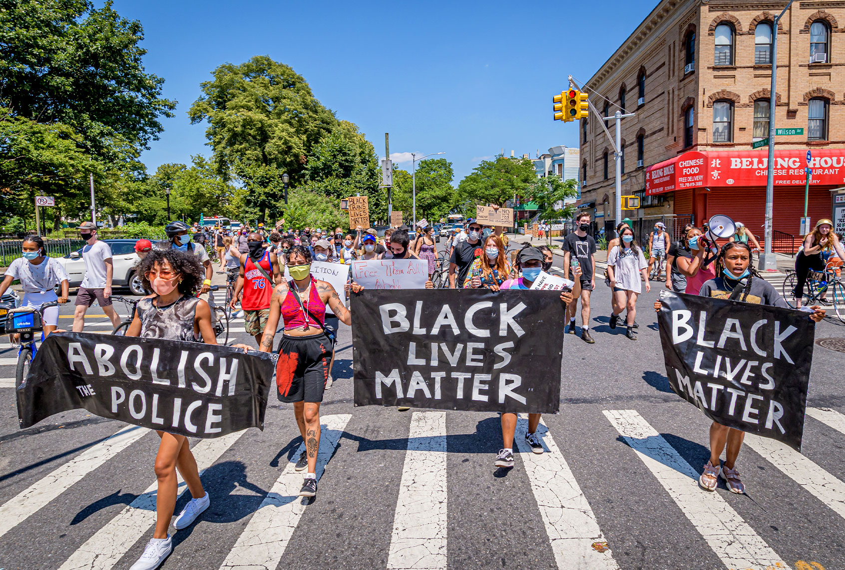Participants marching and holding banners at the front of the match. Brooklynites gathered at Irving Square Park for a march in the streets of Bushwick, demanding justice for all victims of police brutality, bringing light to the situation in Portland, also to make a loud call to defund the NYPD and invest in communities. Street Riders NYC participated by sending bikes to act as a buffer and shield protesters from cars and police. (Erik McGregor/LightRocket via Getty Images)