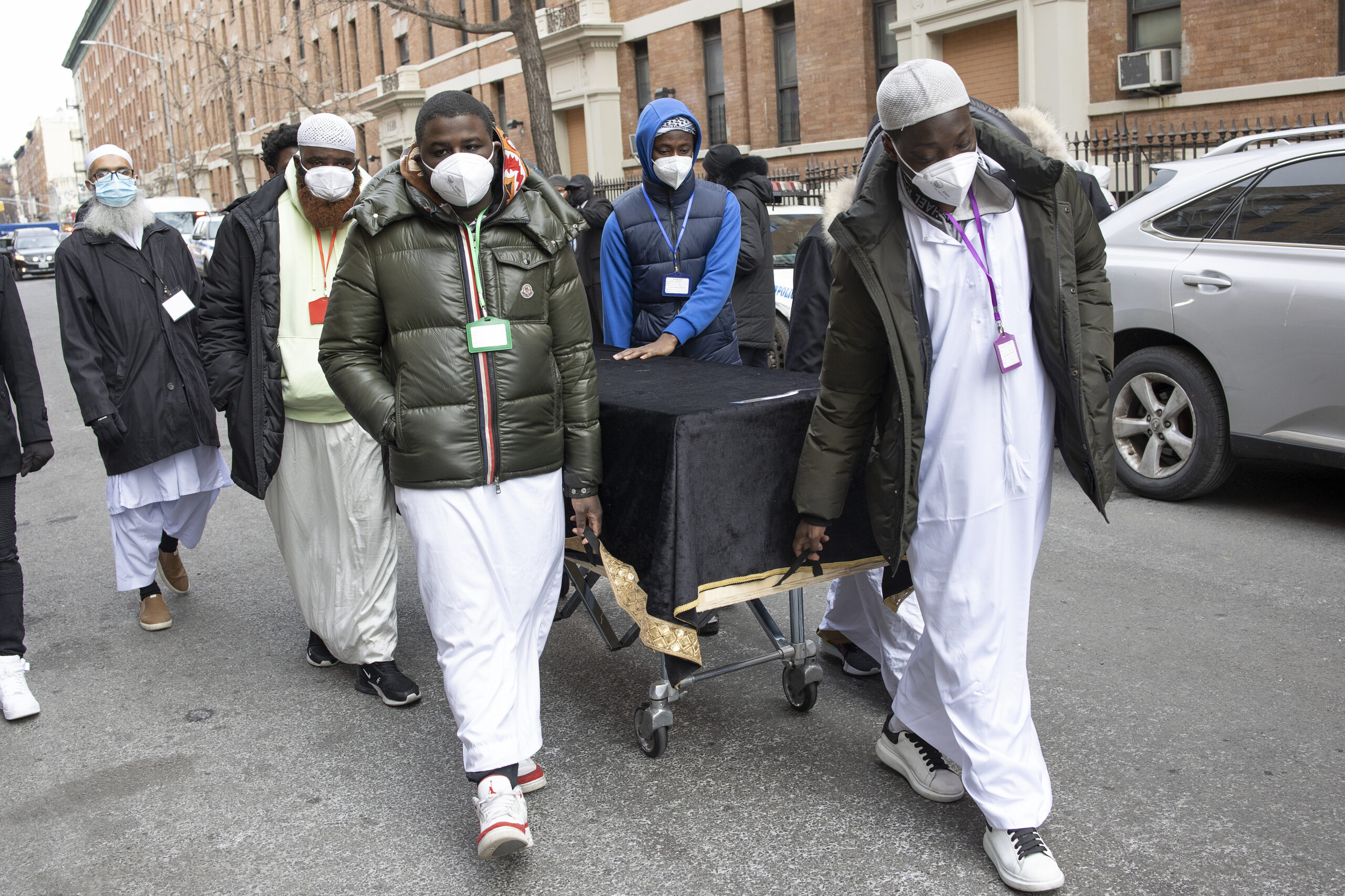 Caskets for 15 victims of a fire that killed 19 people in the Bronx are wheeled into the Islamic Cultural Center for a mass funeral on Jan. 16, 2022. (Andrew Lichtenstein/Corbis via Getty Images)