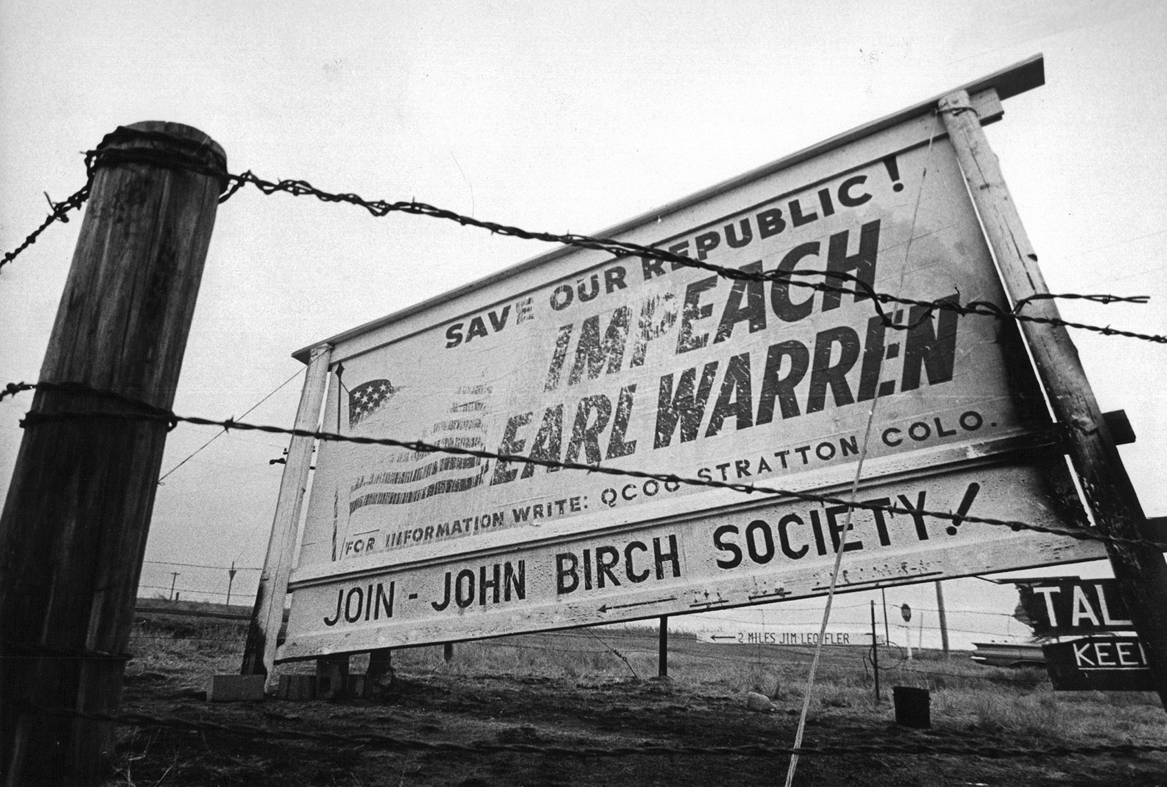 Sign at Stratton, Colo, Shows Damage From Attempts To Destroy It Erected by the John Birch Society, billboard calls for impeachment of Earl Warren. Credit: Denver Post (Denver Post via Getty Images)