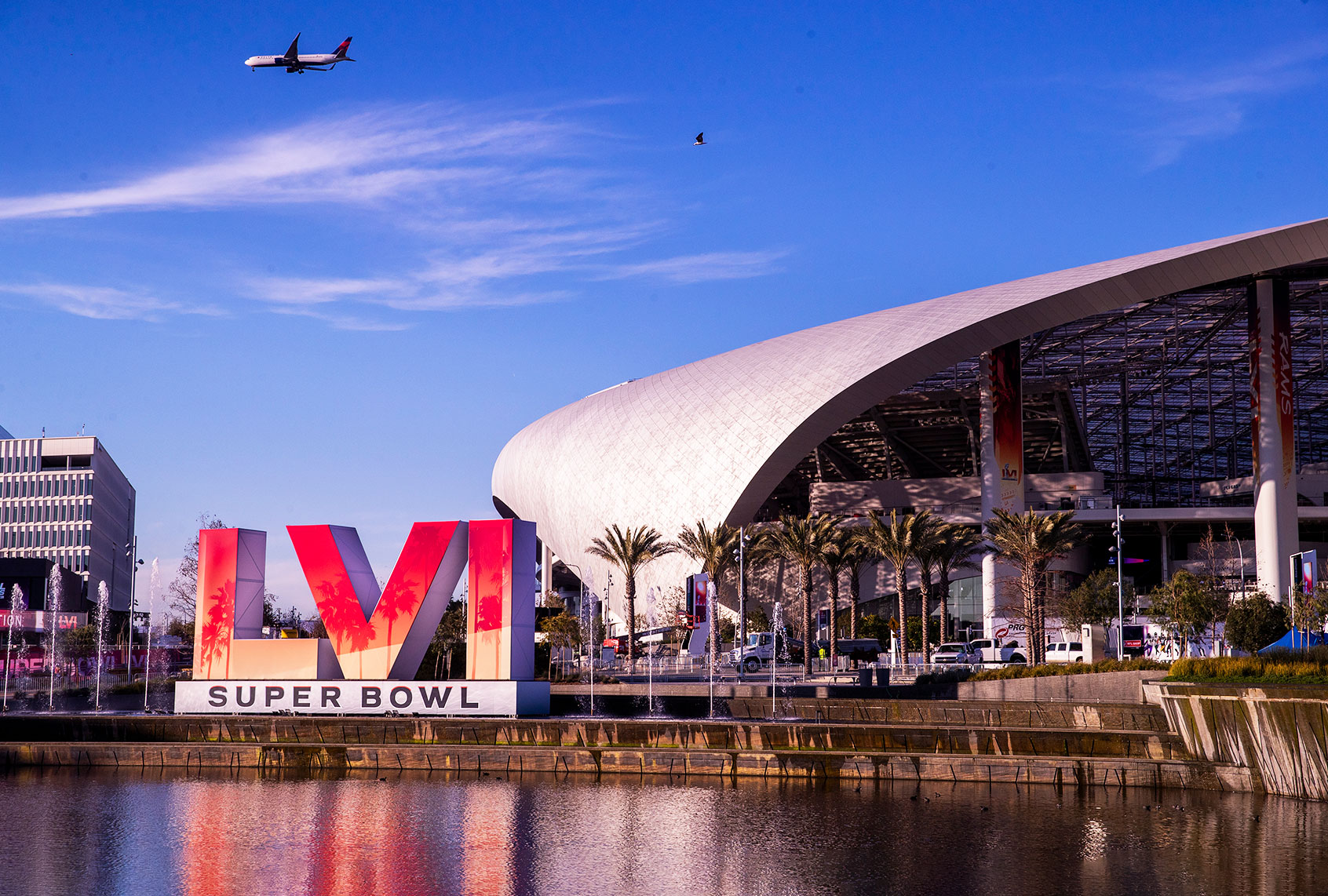 Workers make last minute preparations for the Super Bowl as viewed from the lake at SoFi Stadium in Los Angeles Wednesday, Feb. 9, 2022. (Allen J. Schaben / Los Angeles Times via Getty Images)