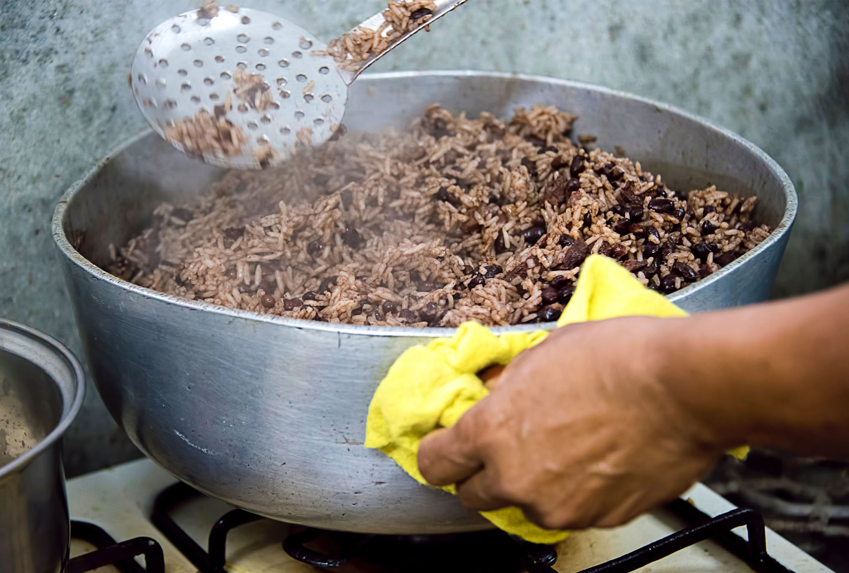 Woman cooking traditional rice and beans (Getty Images/Karen Brodie)
