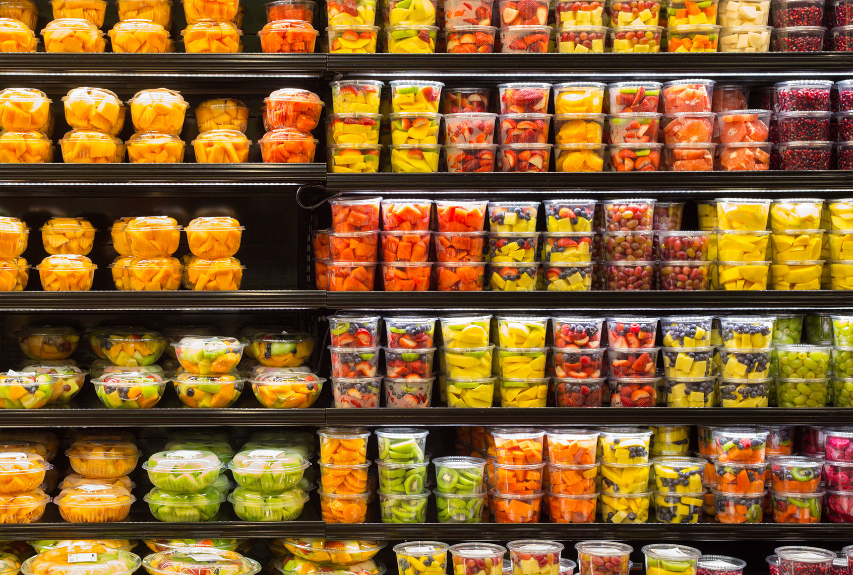 Assortment of cut fruit in containers on display for sale (Getty Images/littleny)