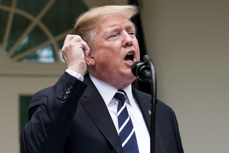 U.S. President Donald Trump pretends to make a phone call while speaking in the Rose Garden at the White House May 22, 2019 in Washington, DC. (Chip Somodevilla/Getty Images)