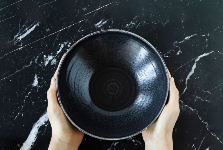 Woman's hands holding an empty dish bowl (Getty Images/Marinela Malcheva)