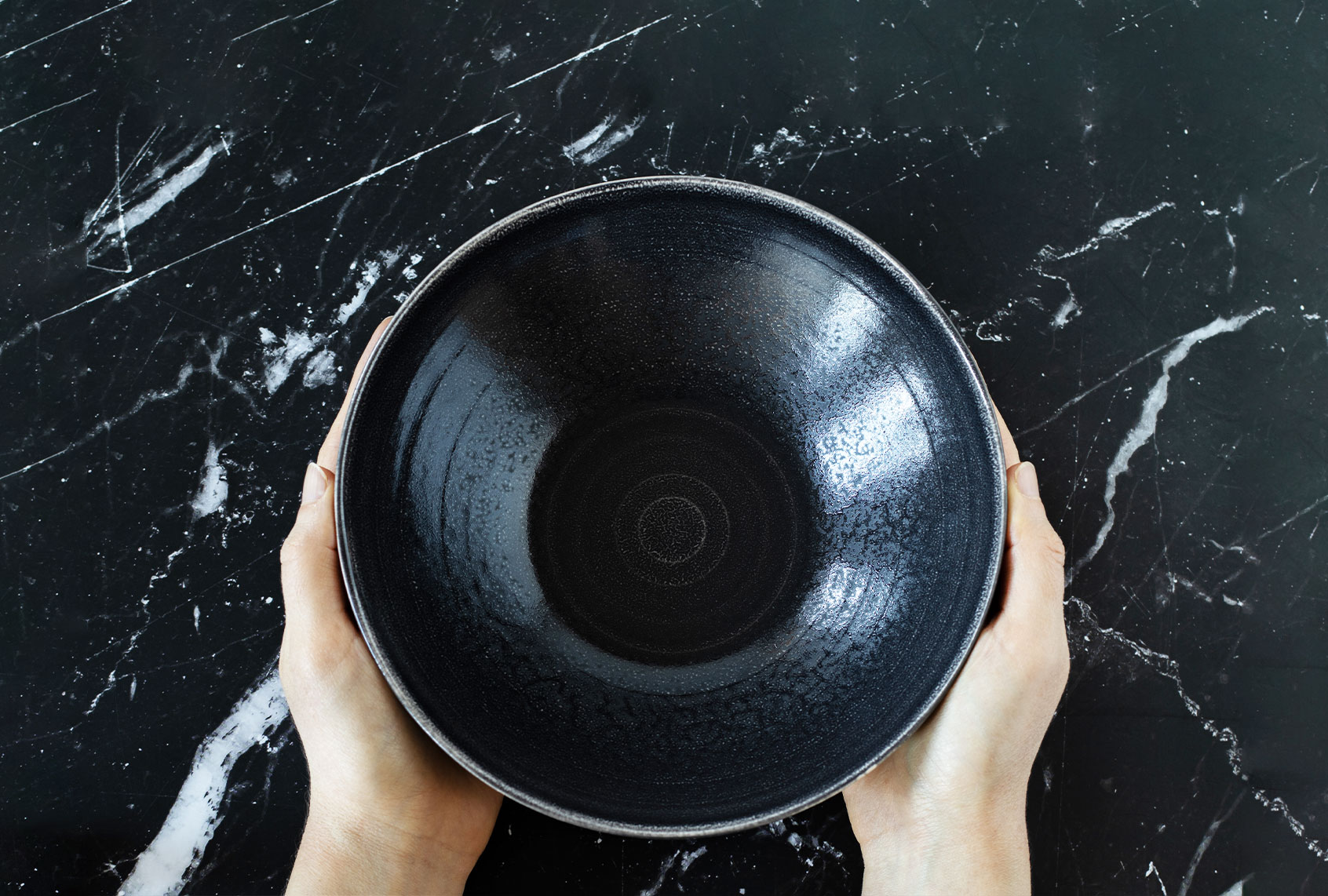 Woman's hands holding an empty dish bowl (Getty Images/Marinela Malcheva)