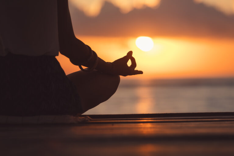 Young woman practicing yoga on the beach. (Kristina Jovanovic / Getty Images)