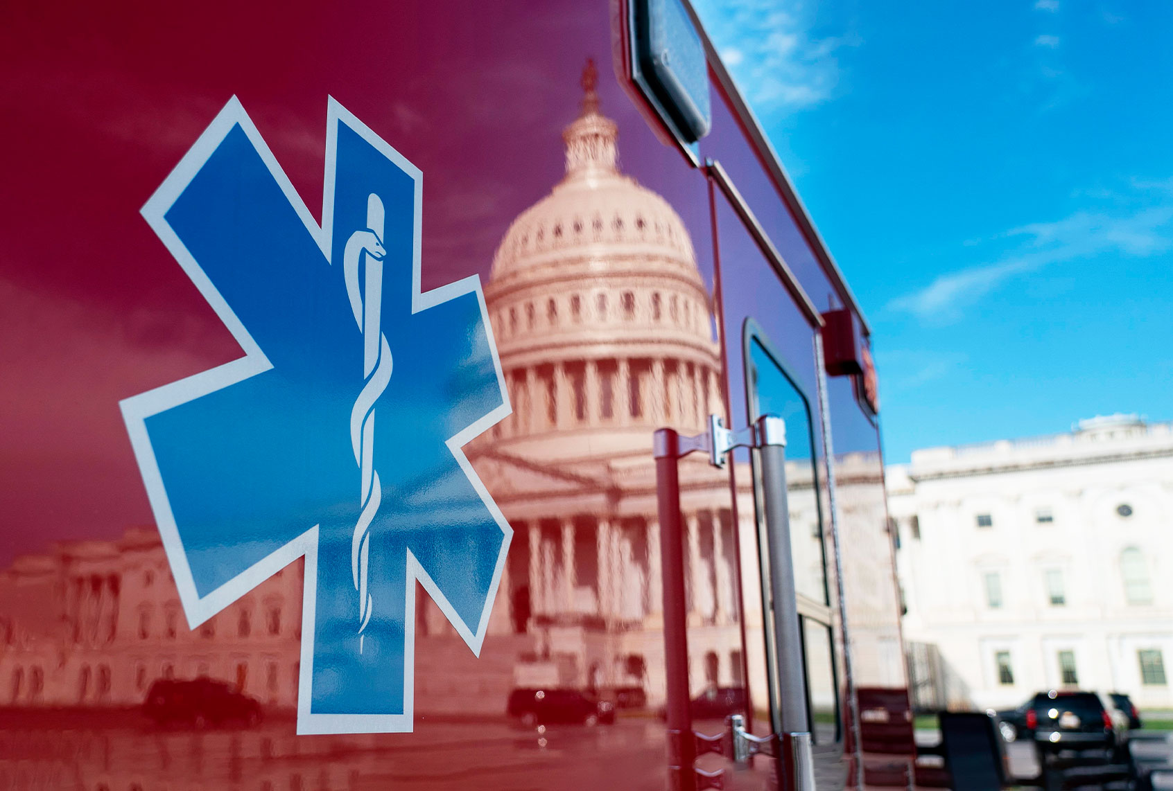 The US Capitol is reflected in a standby ambulance on March 27, 2020, in Washington, DC. (ALEX EDELMAN/AFP via Getty Images)