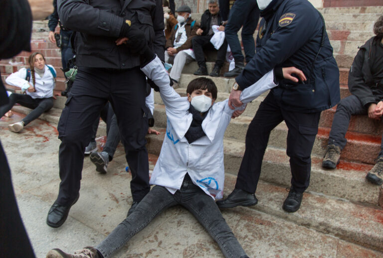 MADRID, SPAIN - 2022/04/06: Activists from the International Collective Scientists Rebellion and Extinction Rebellion are arrested after filling the facade of the Congress of Deputies with biodegradable fake blood against the climate crisis. ((Photo by Fer Capdepon Arroyo/Pacific Press/LightRocket via Getty Images))