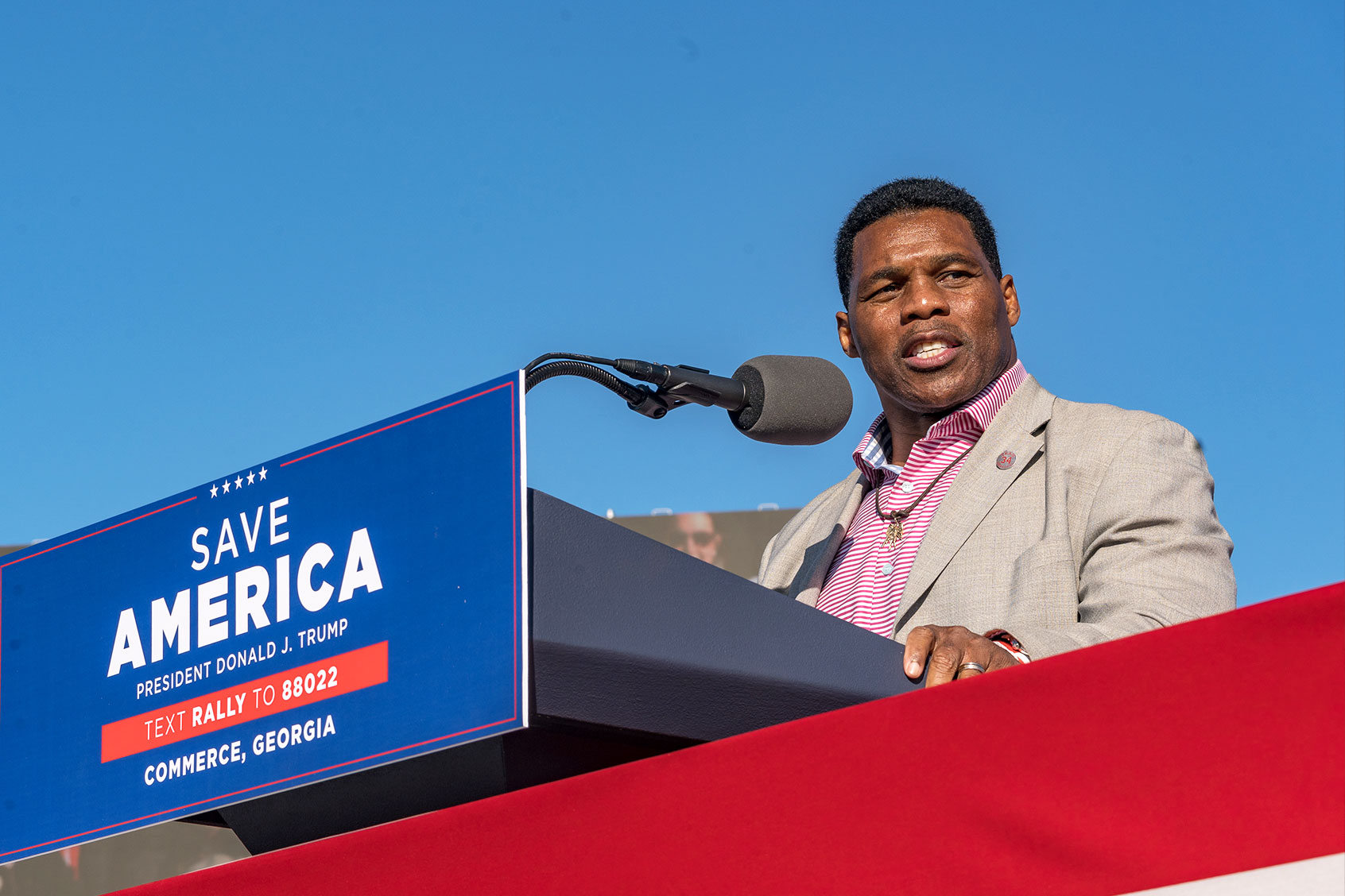 Former Heisman Trophy winner and candidate for US Senate Herschel Walker (R-GA) speaks to supporters of former U.S. President Donald Trump during a rally at the Banks County Dragway on March 26, 2022 in Commerce, Georgia. This event is a part of Trump's Save America Tour around the United States. (Megan Varner/Getty Images)