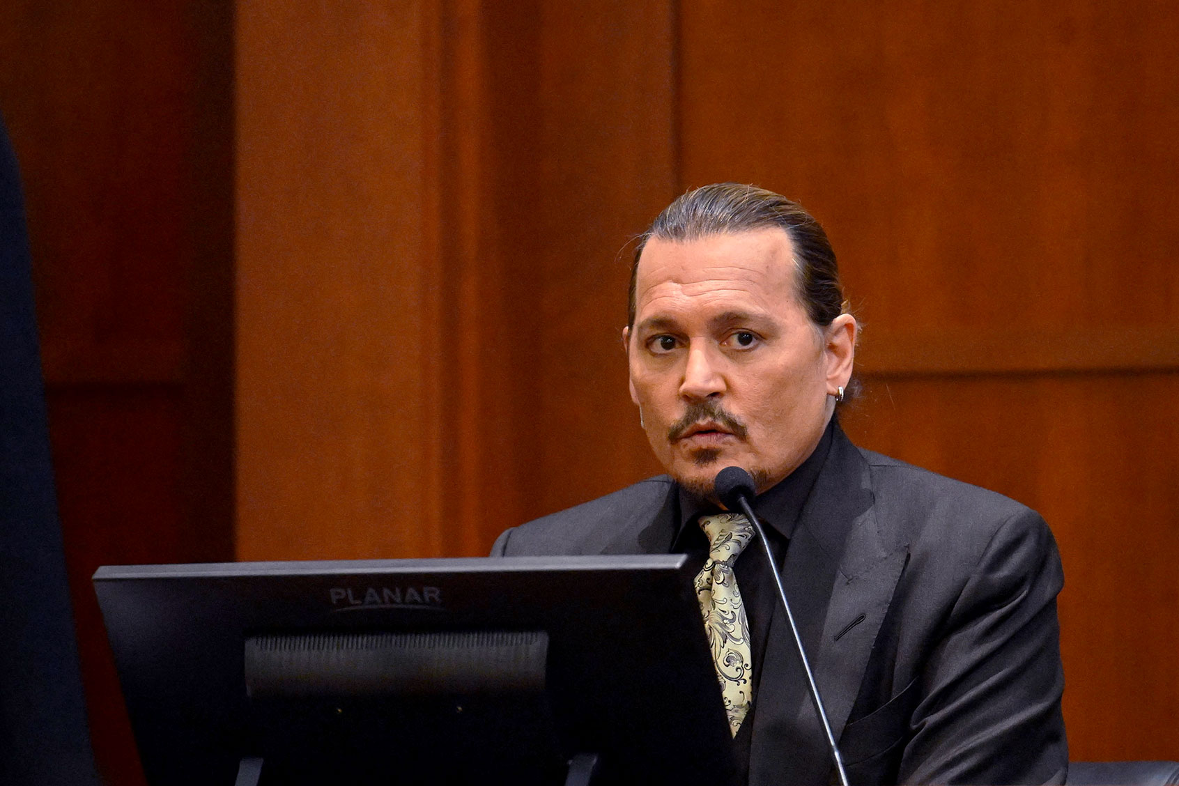 US actor Johnny Depp testifies during his defamation trial in the Fairfax County Circuit Courthouse in Fairfax, Virginia, on April 19, 2022. - Depp is suing ex-wife Amber Heard for libel after she wrote an op-ed piece in The Washington Post in 2018 referring to herself as a public figure representing domestic abuse. (JIM WATSON/POOL/AFP via Getty Images)