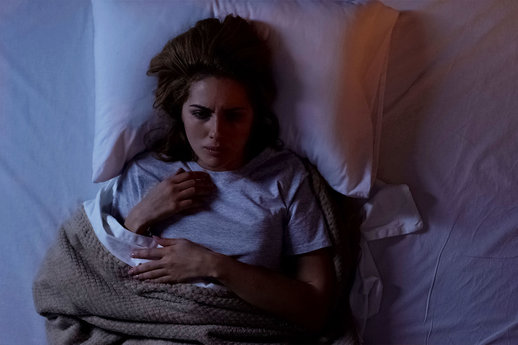Woman struggling to sleep at night (Getty Images/Motortion)