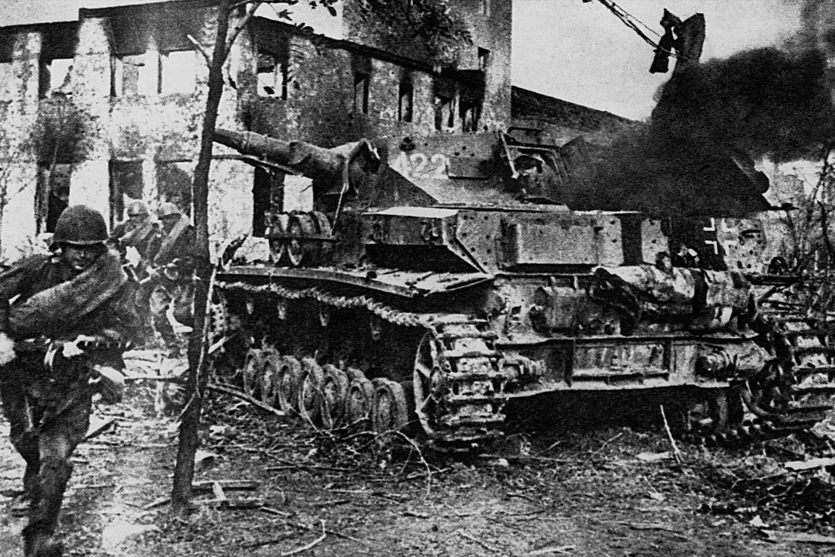 A Soviet soldier runs past a burning German tank in the battle for Kiev during World War II. (CORBIS/Corbis via Getty Images)