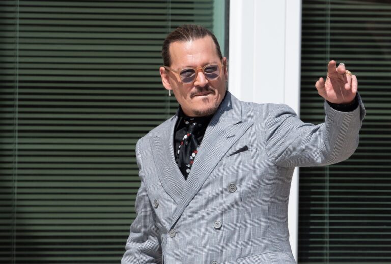 Johnny Depp gestures to his fans during a break outside court during the Johnny Depp and Amber Heard civil trial at Fairfax County Circuit Court on May 19, 2022 in Fairfax, Virginia (Cliff Owen/Consolidated News Pictures/Getty Images)