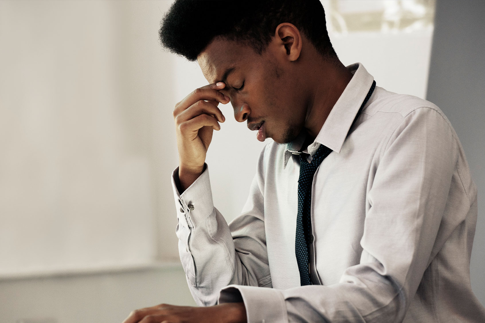Man with a headache, under stress (Getty Images/Colin Hawkins)