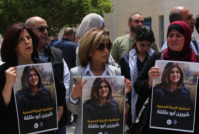 Press members holding photos of female reporter of Al-Jazeera television channel Shireen Abu Akleh, died as a result of fire opened by Israeli soldiers, are seen in front of the hospital as Akleh's dead body is brought to Al- Najah Hospital for autopsy in Nablus, West Bank on May 11, 2022. (Nedal Eshtayah/Anadolu Agency via Getty Images)