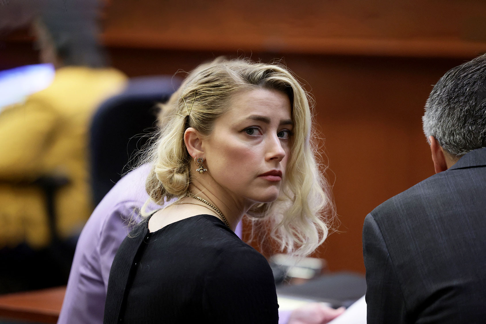 US actress Amber Heard waits before the jury said that they believe she defamed ex-husband Johnny Depp, while announcing split verdicts in favor of both her ex-husband Johnny Depp and Heard on their claim and counter-claim in the Depp v. Heard civil defamation trial at the Fairfax County Circuit Courthouse in Fairfax, Virginia, on June 1, 2022. (EVELYN HOCKSTEIN/POOL/AFP via Getty Images)