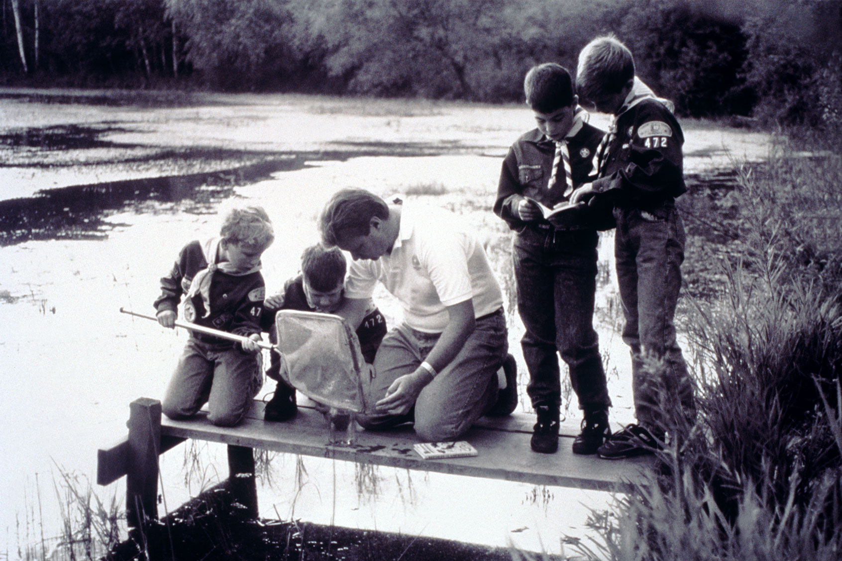 Boy Scouts Examining Specimens on Dock (Getty Images/Ed Bock)