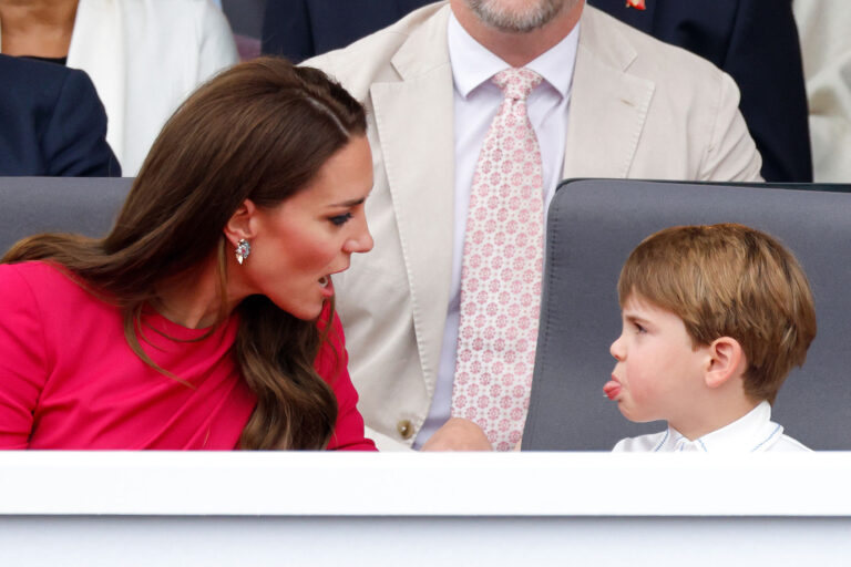 Prince Louis of Cambridge sticks his tongue out at his mother Catherine, Duchess of Cambridge as they attend the Platinum Pageant on The Mall on June 5, 2022 in London, England. (Max Mumby/Indigo/Getty Images)