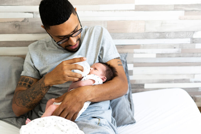 Father bottle-feeding his newborn baby (Getty Images/Westend61)