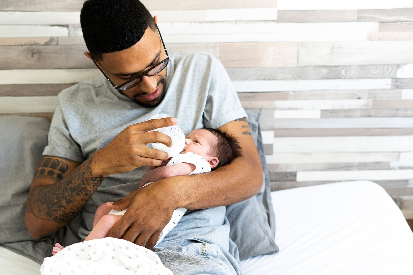 Father bottle-feeding his newborn baby (Getty Images/Westend61)