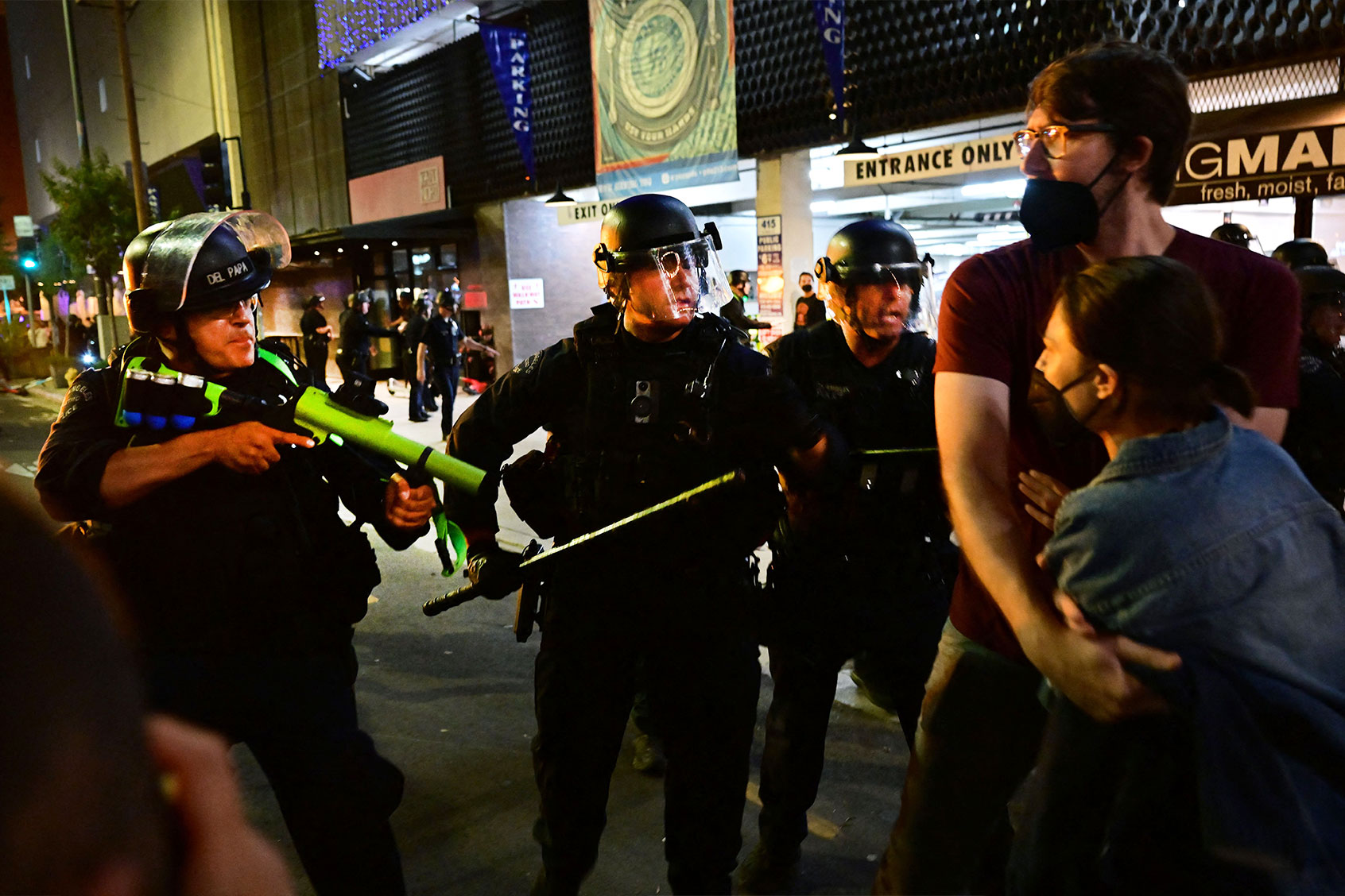 Police holding rubber-bullet guns and batons move to disperse a crowd of abortion rights activists protesting after the overturning of Roe Vs. Wade by the US Supreme Court, in Downtown Los Angeles, on June 24, 2022. (FREDERIC J. BROWN/AFP via Getty Images)