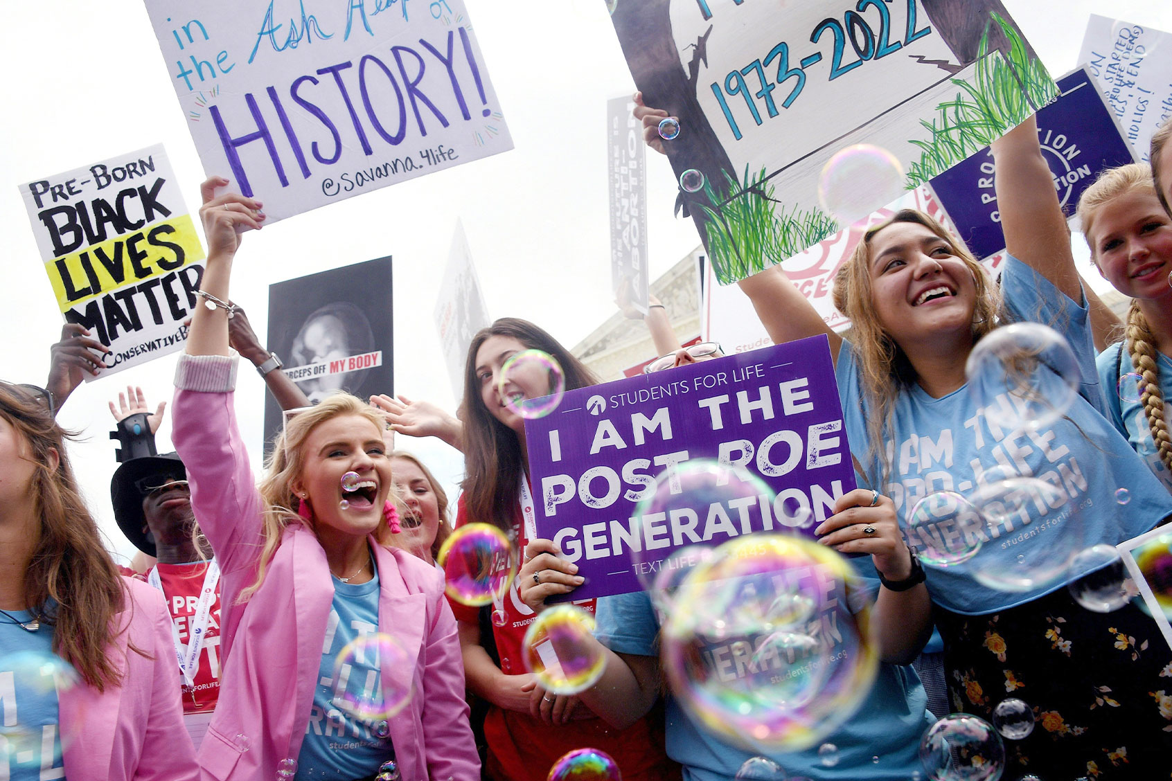 Anti-abortion campaigners celebrate outside the US Supreme Court in Washington, DC, on June 24, 2022. The conservative-dominated court overturned the landmark 1973 "Roe v Wade" decision that enshrined a woman's right to an abortion and said individual states can permit or restrict the procedure themselves. (OLIVIER DOULIERY / AFP) (Photo by OLIVIER DOULIERY/AFP via Getty Images)