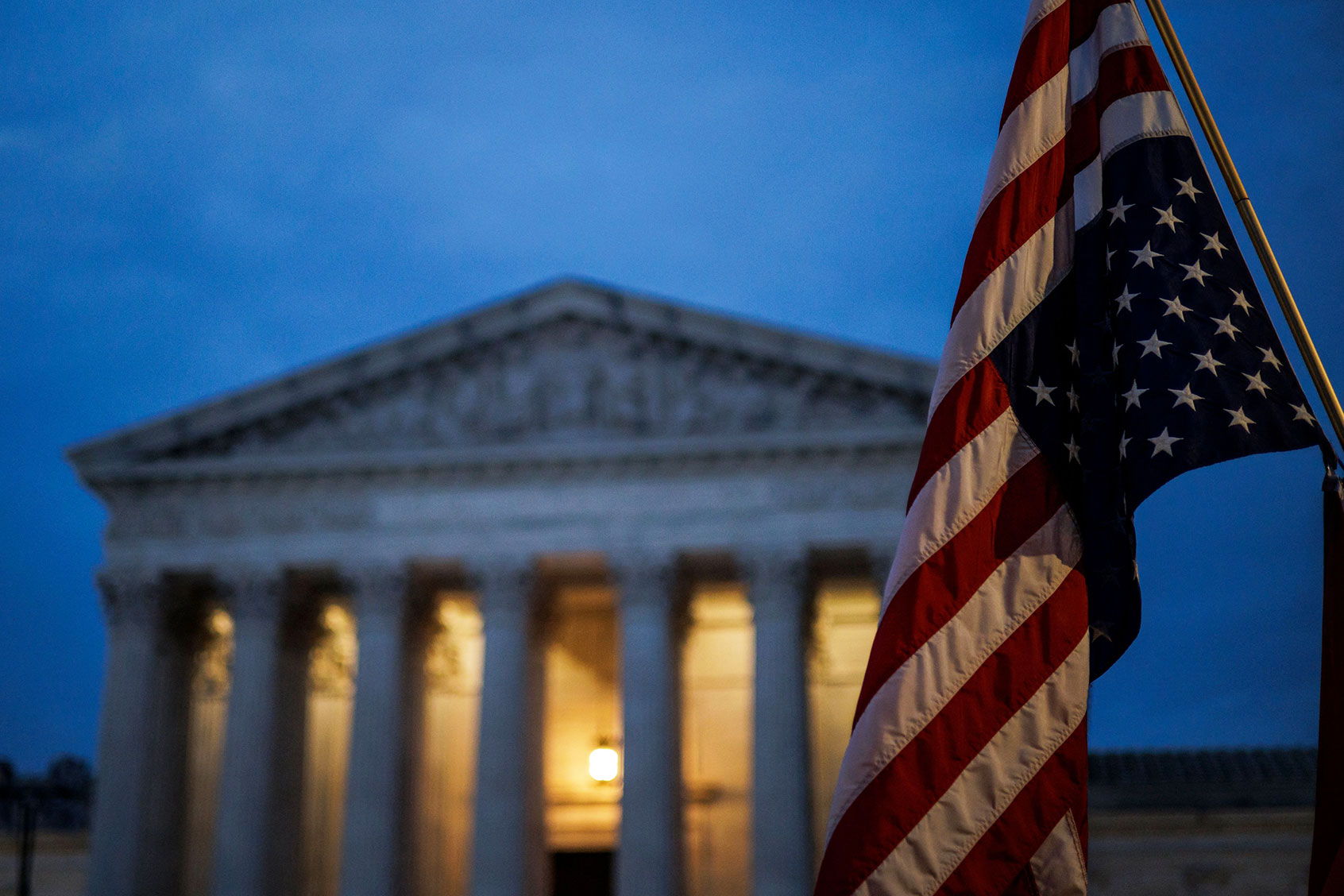 An abortion rights activist flies an upside-down US flag, the international sign of distress, outside of the US Supreme Court during a protest in Washington, DC, on June 26, 2022, two days after the US Supreme Court scrapped half-century constitutional protections for the procedure. (SAMUEL CORUM/AFP via Getty Images)