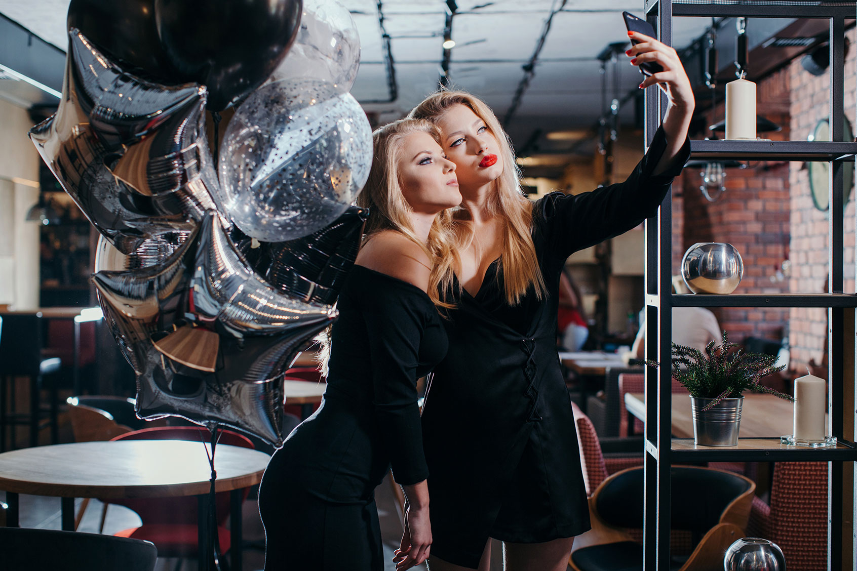 Two women taking selfies (Getty Images/honey_and_milk)