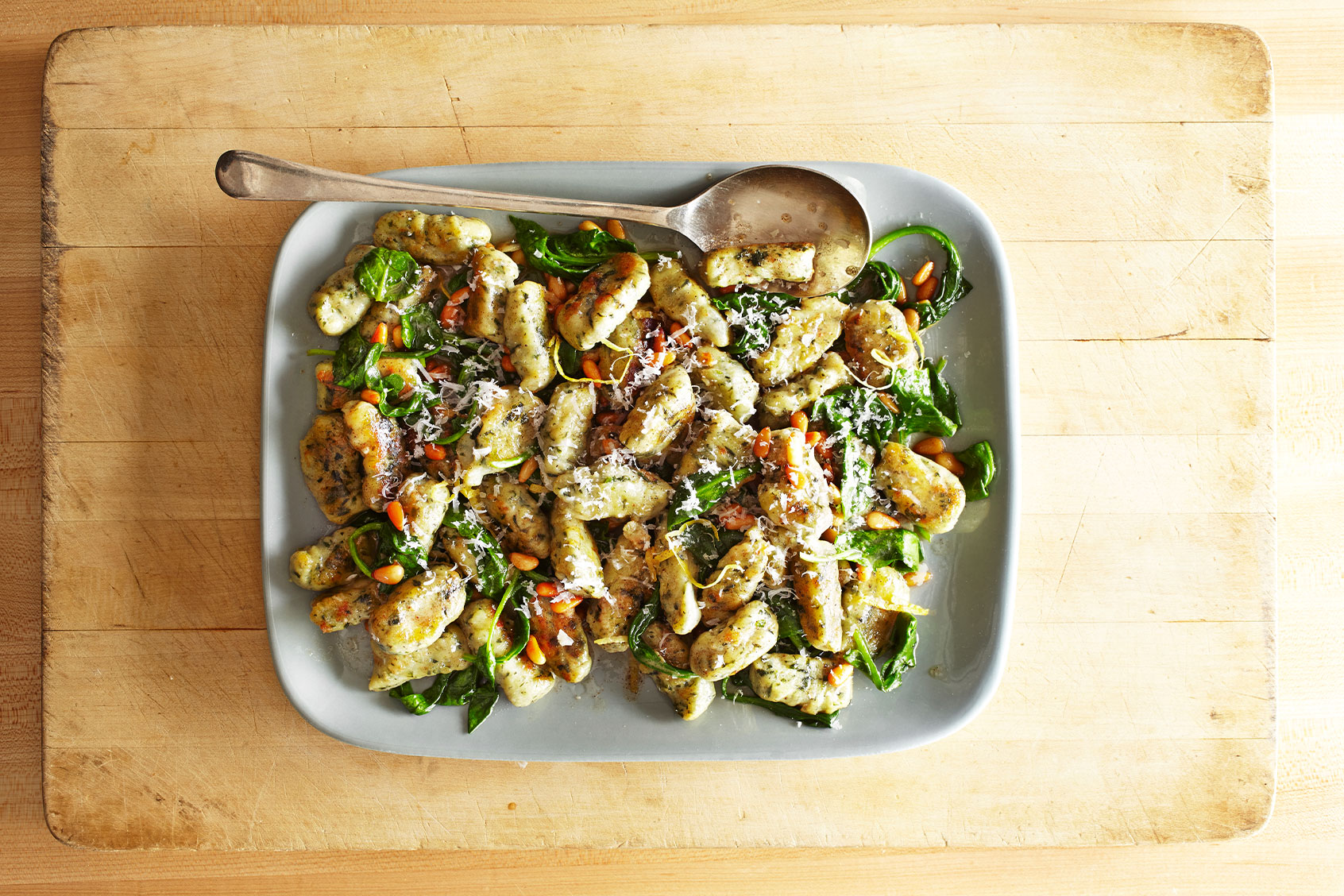 A plate with gnocchi, spinach, pine nuts and shredded cheese (Getty Images/Annabelle Breakey)