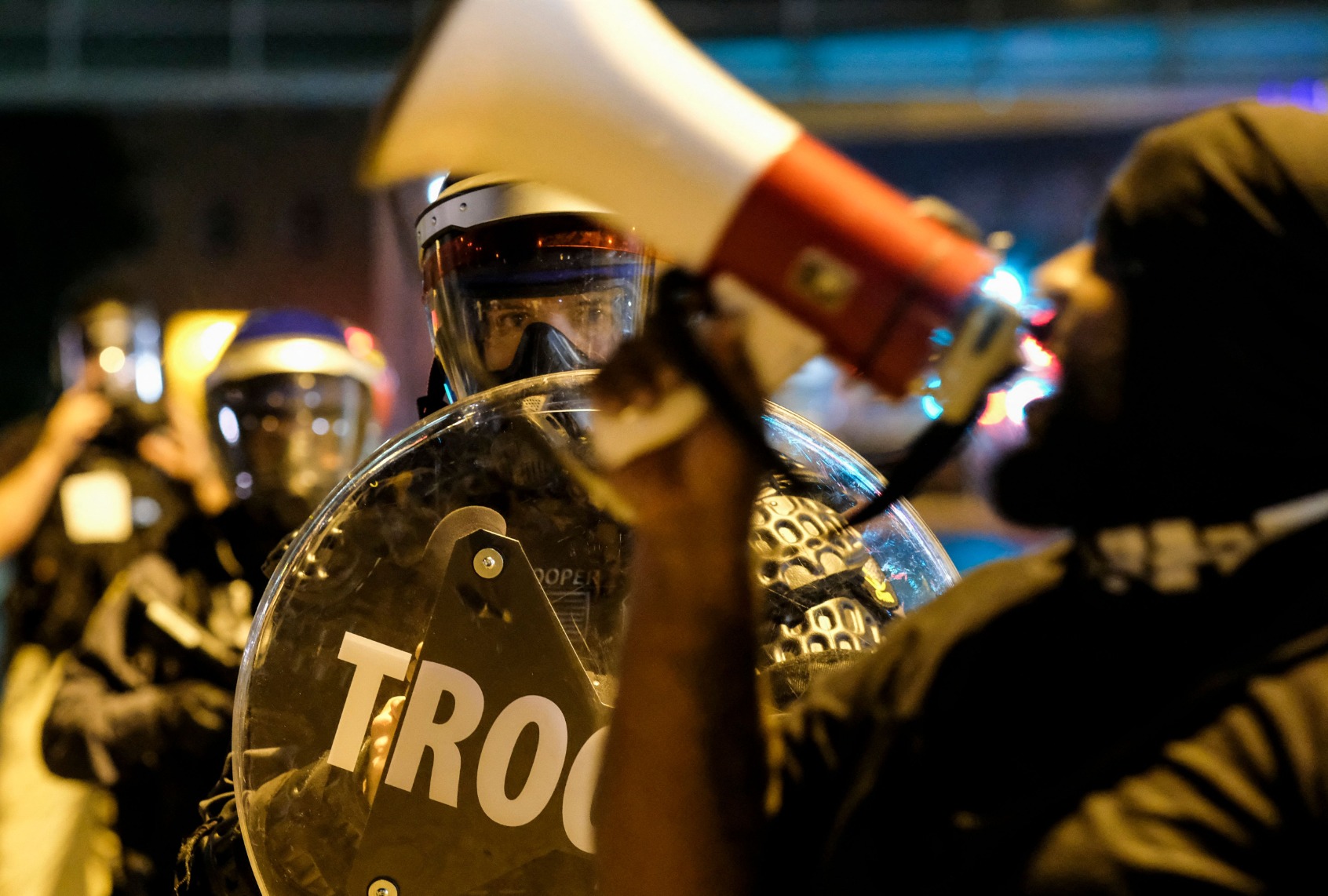Troopers in riot gear watch as demonstrators gather outside Akron City Hall to protest the killing of Jayland Walker, shot by police, in Akron, Ohio, July 3, 2022. (MATTHEW HATCHER/AFP via Getty Images)
