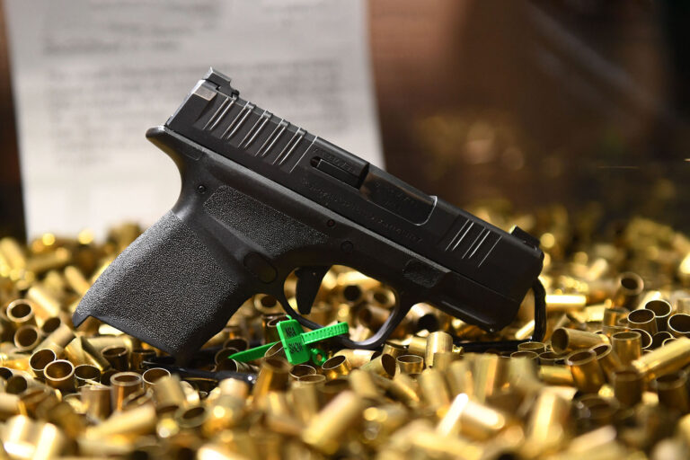 A Springfield Armory Hellcat 9mm micro-sized pistol that has fired 20,000 rounds is displayed with ammunition shell casings during the National Rifle Association (NRA) Annual Meeting at the George R. Brown Convention Center, in Houston, Texas on May 28, 2022. - America's powerful National Rifle Association kicked off a major convention in Houston Friday, days after the horrific massacre of children at a Texas elementary school, but a string of high-profile no-shows underscored deep unease at the timing of the gun lobby event. (PATRICK T. FALLON/AFP via Getty Images)