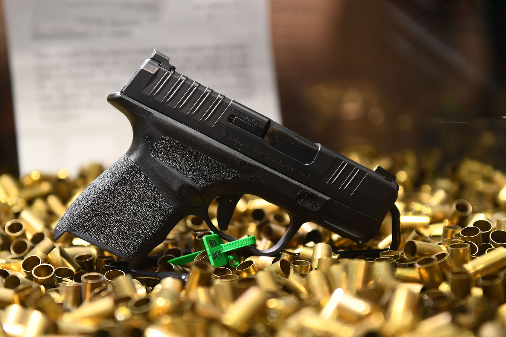 A Springfield Armory Hellcat 9mm micro-sized pistol that has fired 20,000 rounds is displayed with ammunition shell casings during the National Rifle Association (NRA) Annual Meeting at the George R. Brown Convention Center, in Houston, Texas on May 28, 2022. - America's powerful National Rifle Association kicked off a major convention in Houston Friday, days after the horrific massacre of children at a Texas elementary school, but a string of high-profile no-shows underscored deep unease at the timing of the gun lobby event. (PATRICK T. FALLON/AFP via Getty Images)
