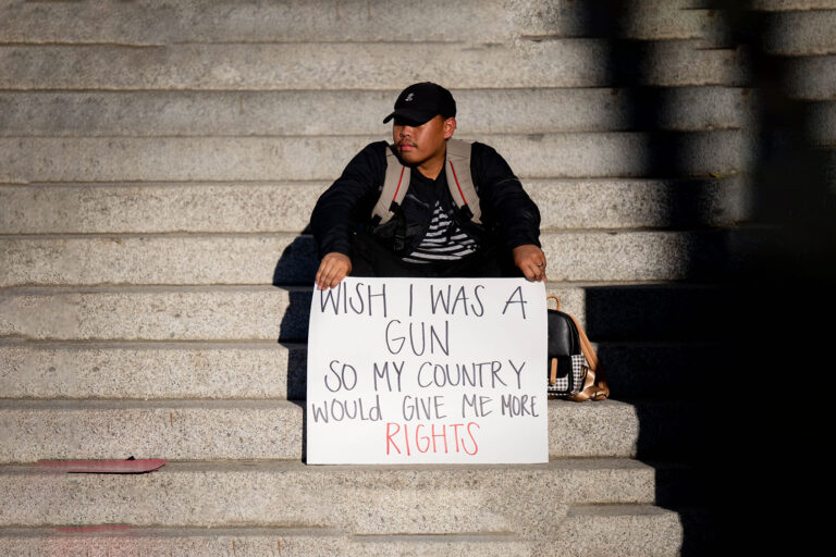 Pro-choice supporter holds a sign comparing women's rights and gun rights during a rally to protest the Supreme Court's decision to overturn Roe v. Wade in downtown Riverside on Friday, June 24, 2022. (Watchara Phomicinda/MediaNews Group/The Press-Enterprise via Getty Images)