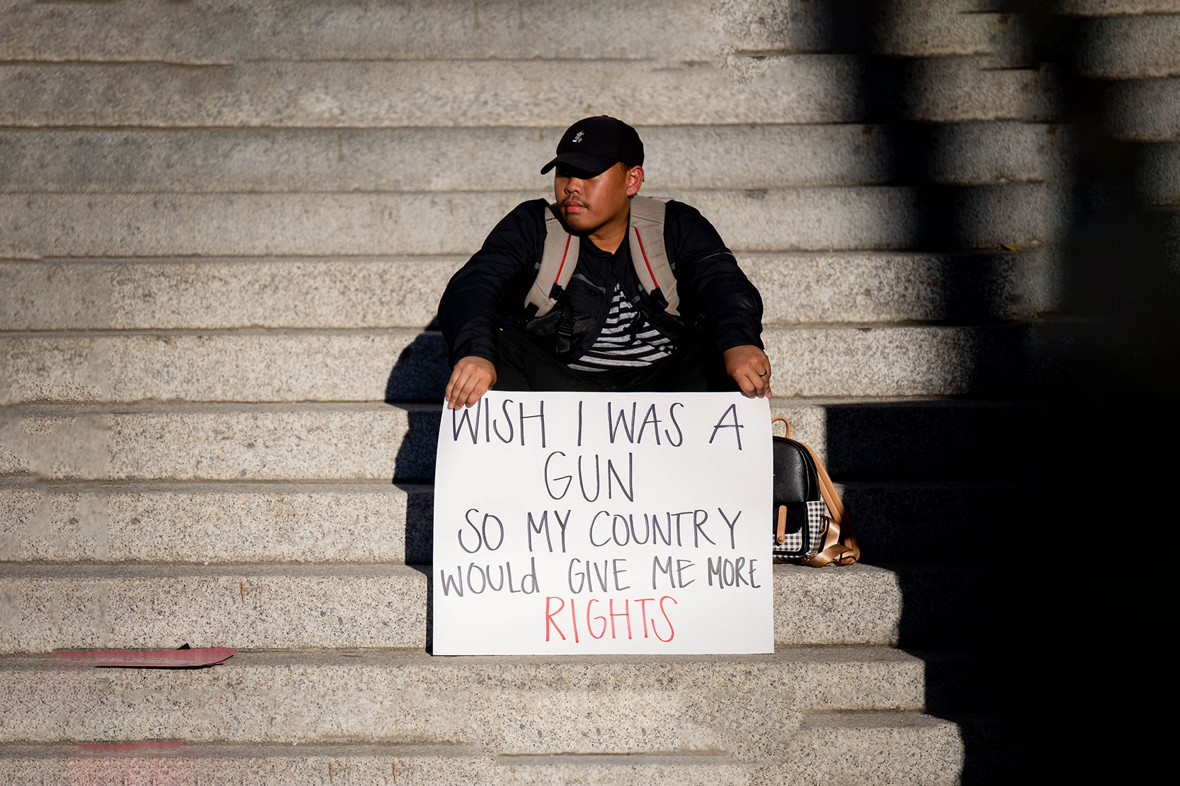 Pro-choice supporter holds a sign comparing women's rights and gun rights during a rally to protest the Supreme Court's decision to overturn Roe v. Wade in downtown Riverside on Friday, June 24, 2022. (Watchara Phomicinda/MediaNews Group/The Press-Enterprise via Getty Images)
