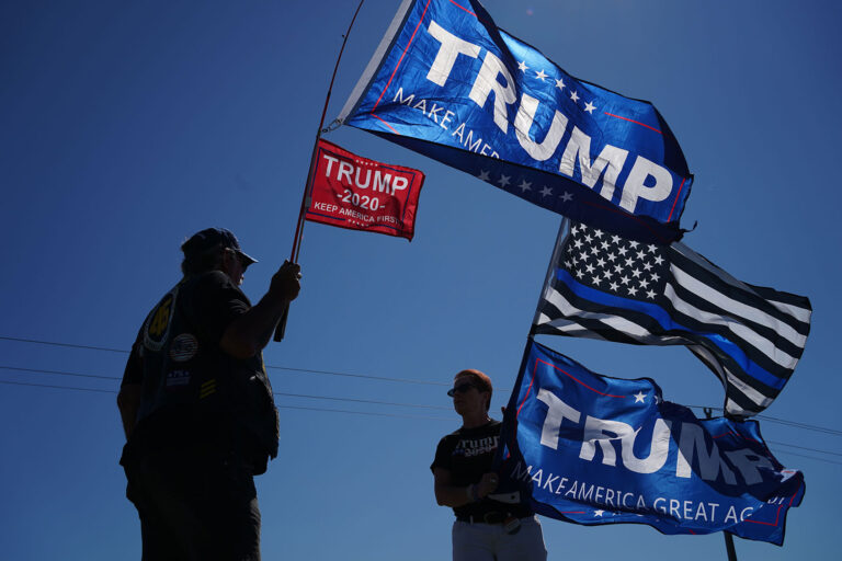 Donald Trump supporters wave flags on August 17, 2020 in Mankato, Minnesota (KEREM YUCEL/AFP via Getty Images)