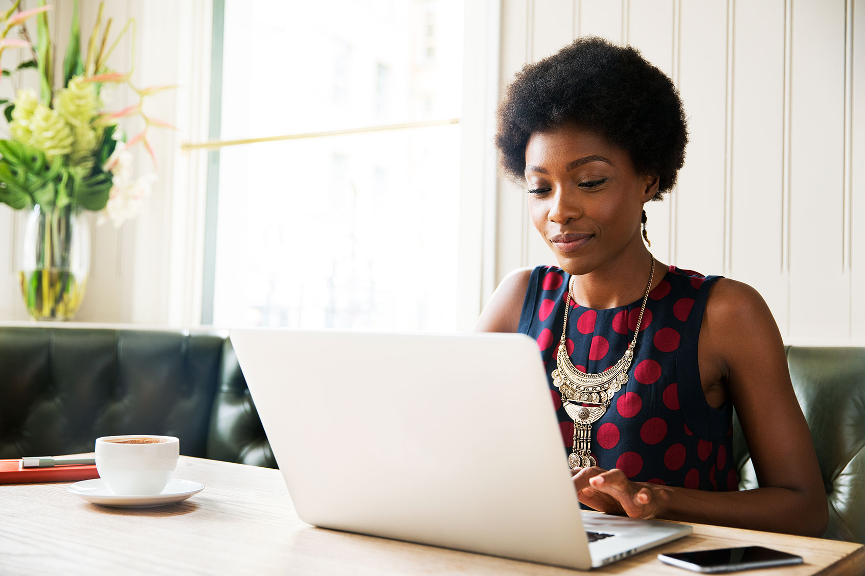 Woman using laptop at table (Getty Images/Tim Robberts)