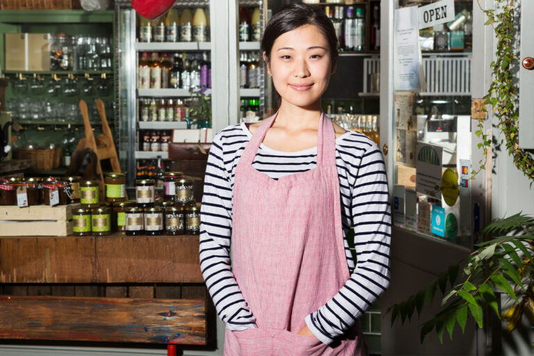 Female shop keeper wearing an apron (Getty Images/Betsie Van Der Meer)