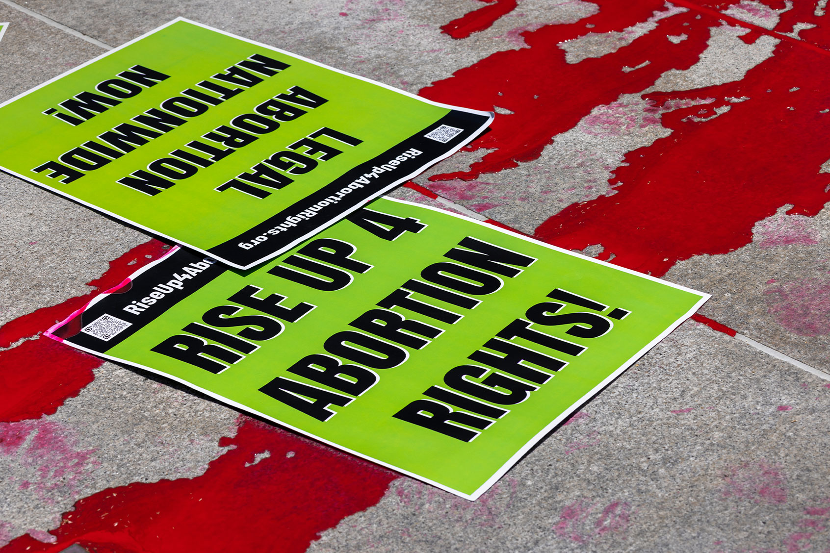 Paint spreads at a protest on the steps of City Hall to denounce the U.S. Supreme Court decision that ended federal abortion rights protections on July 6, 2022 in Los Angeles, California. (David McNew/Getty Images)