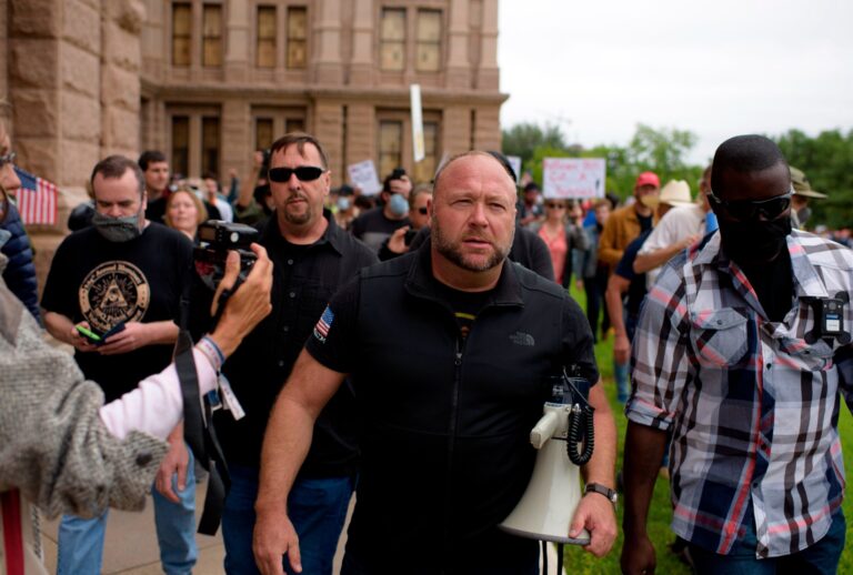 Infowars host Alex Jones marches with protesters during the "Reopen America" rally on April 18, 2020 at the State Capitol in Austin, Texas. (MARK FELIX/AFP /AFP via Getty Images)