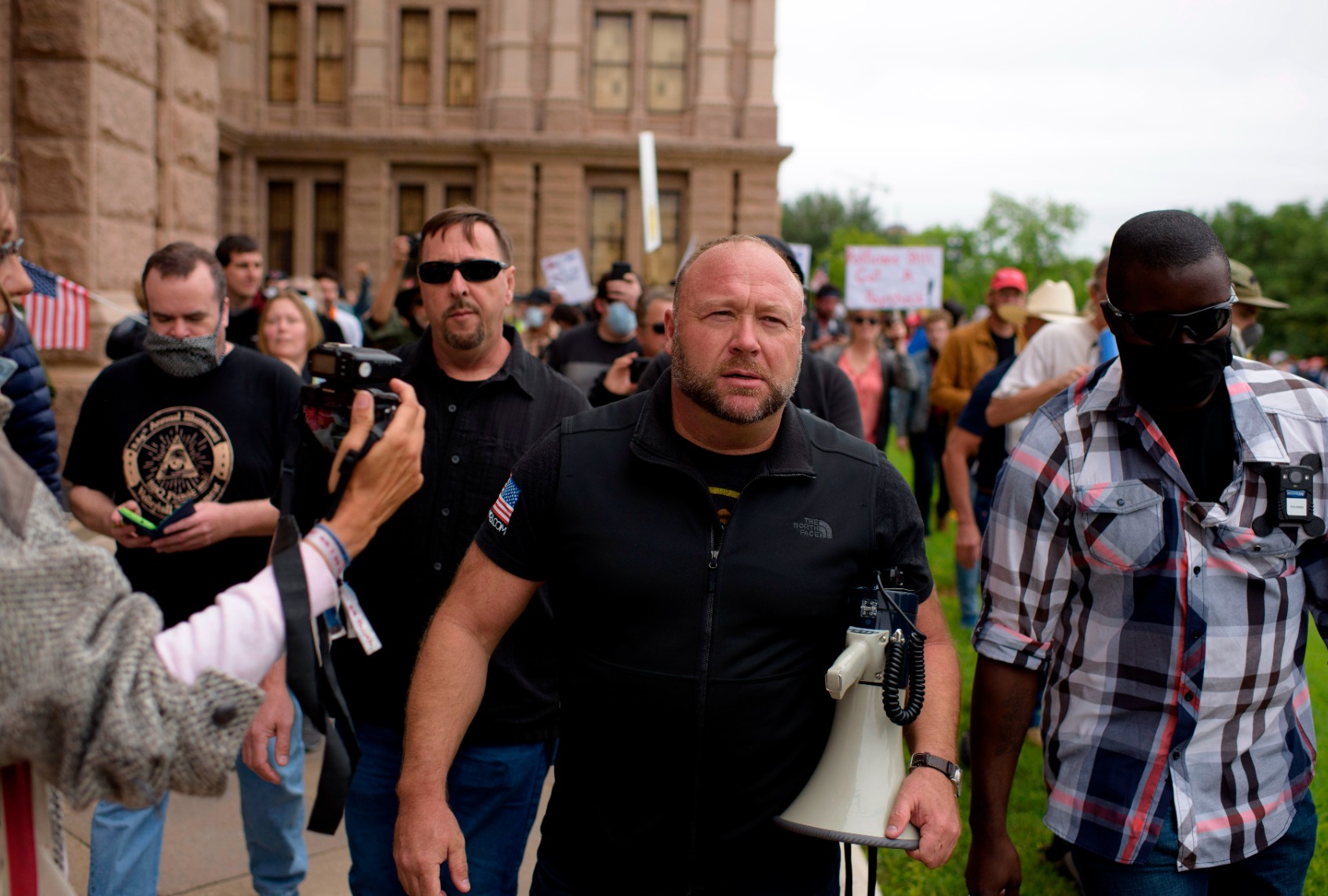 Infowars host Alex Jones marches with protesters during the "Reopen America" rally on April 18, 2020 at the State Capitol in Austin, Texas. (MARK FELIX/AFP /AFP via Getty Images)