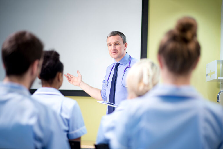Doctor briefing medical students (Getty Images/sturti)