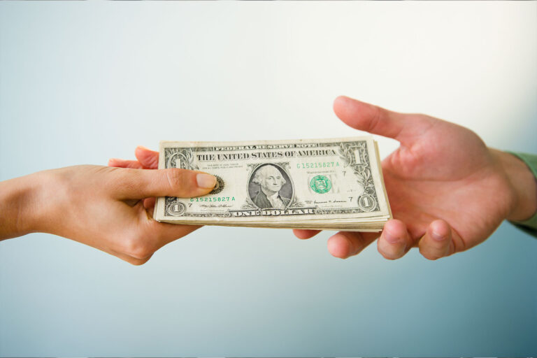 Hands holding banknotes (Getty Images/Jamie Grill)